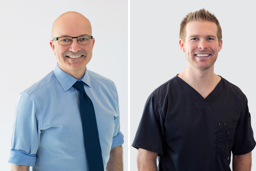 Two male dentists pose for a portrait during a commercial shoot at a dental clinic in Kamloops, British Columbia, Thompson Okanagan region, Canada