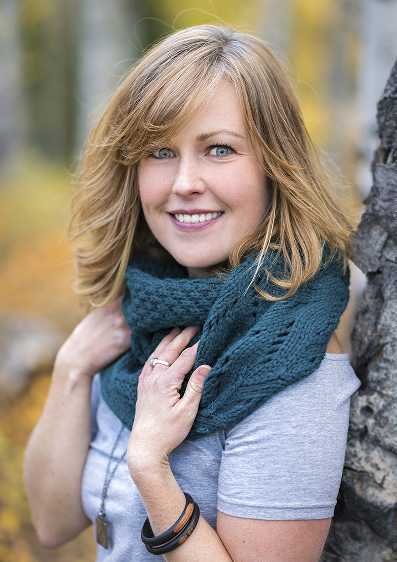 A young woman with blue eyes poses for a portrait on a beautiful fall day near Kamloops, British Columbia, Canada, Thompson Okanagan region