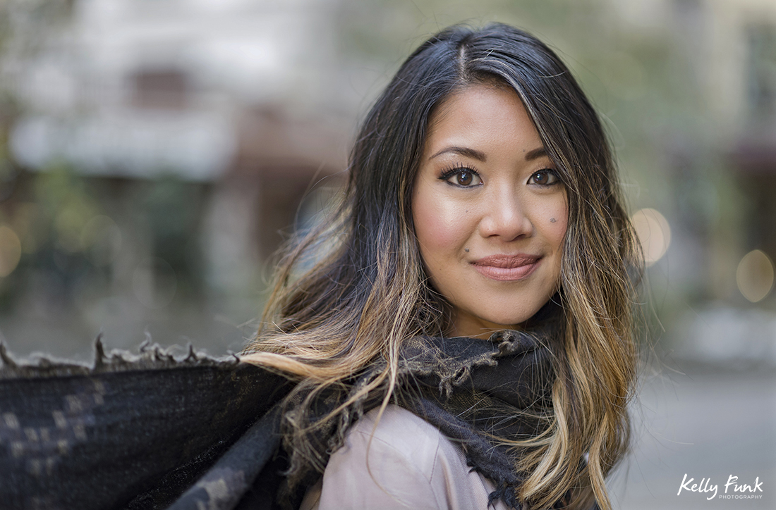 A beautiful young woman poses during a fall fashion and stylized portrait shoot in the village of Sun Peaks, British Columbia, Thompson Okanagan region, Canada