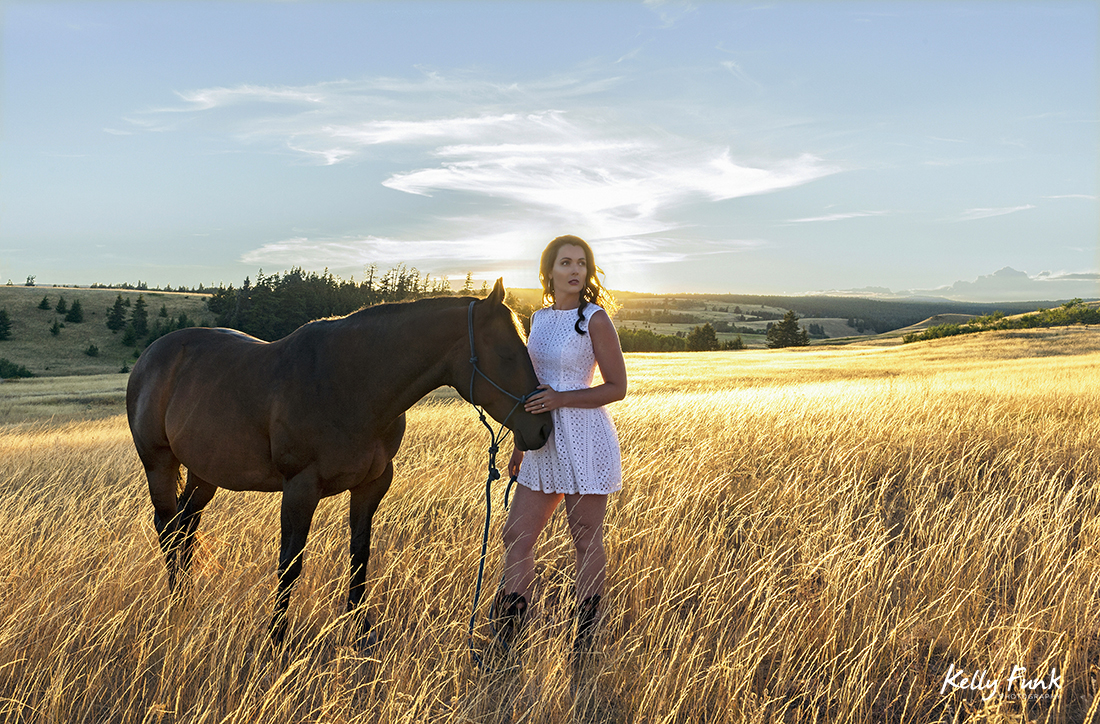 A beautiful young woman and her horse pose at sunset for a stylized portrait, Kamloops, British Columbia, Canada