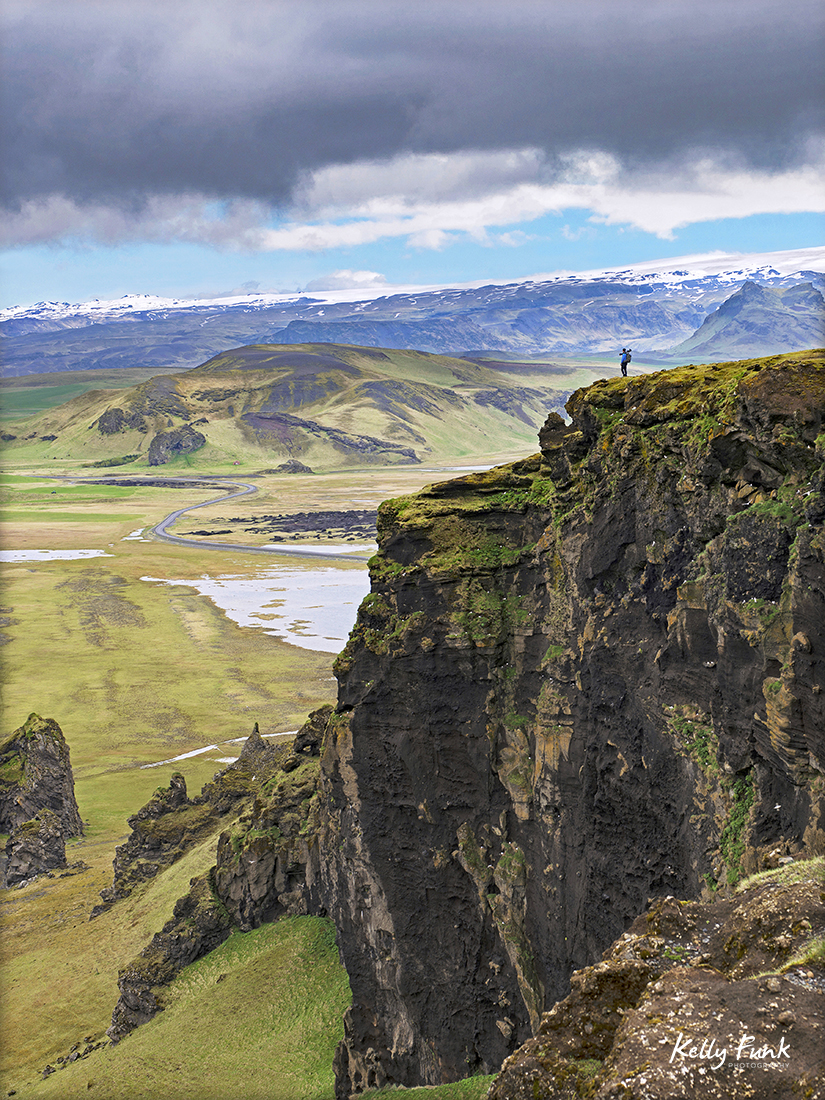 Photographer stands on a cliff in south east Iceland, Europe in the spring