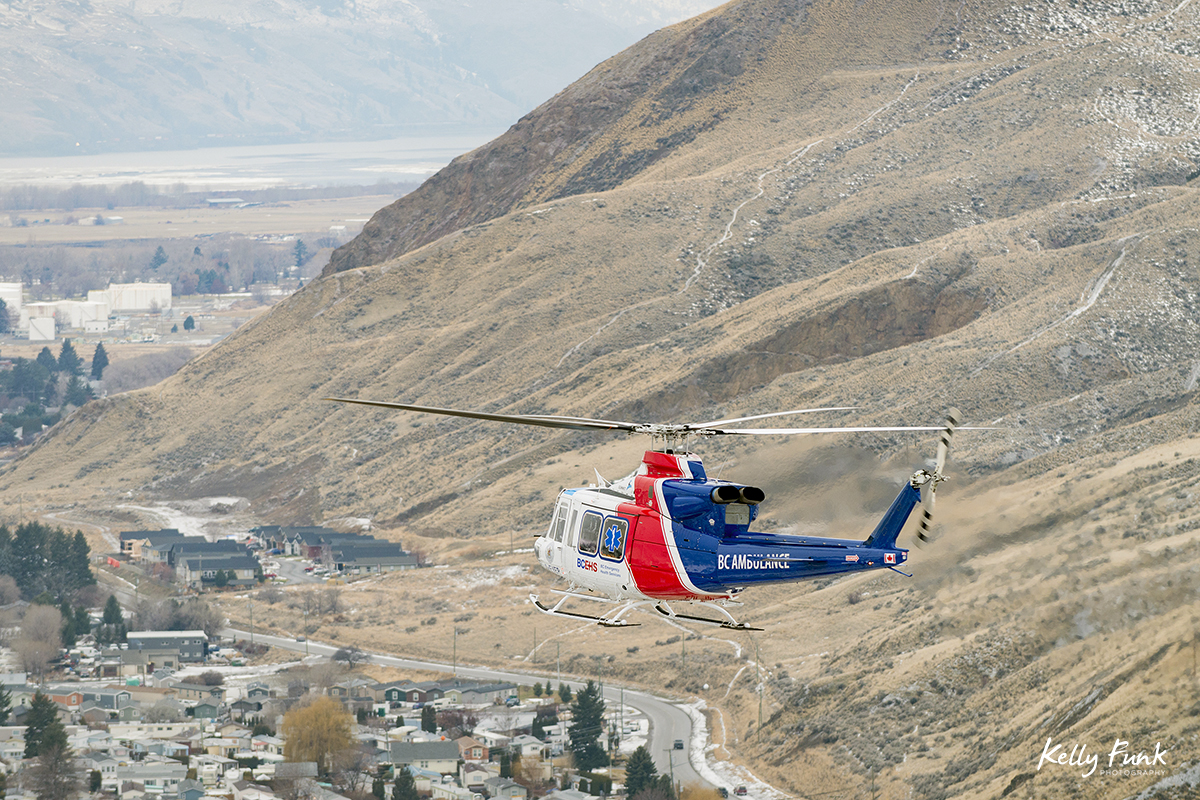 The BC Air Ambulance rescue helicopter is photographed from a second heli during a commercial shoot just west of Kamloops, British Columbia, Canada