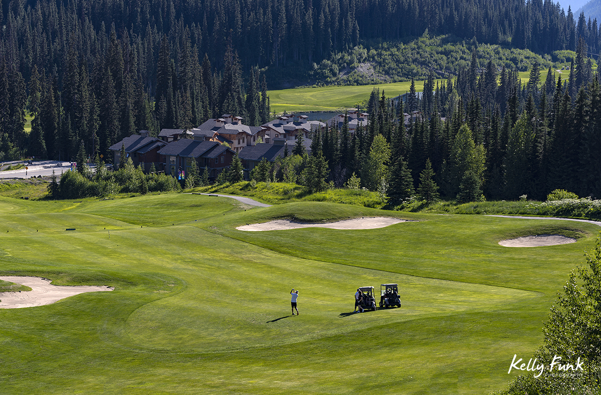 A trio of golfers navigate the 16th hole at the Sun Peaks Resort golf course, north east of Kamloops, British Columbia, Thompson Okanagan region, Canada