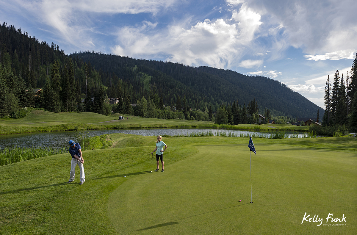 A couple putts on a front nine green at the Sun Peaks Resort golf course, north east of Kamloops, British Columbia, Thompson Okanagan region, Canada