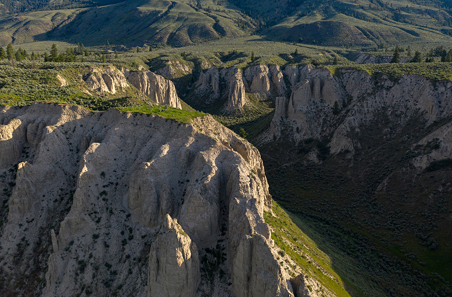 Kelly Funk Kamloops hoodoos east Sunlight kisses the tops of the hoodoo formations at first light east of Kamloops in the Thompson Okanagan region of British Columbia Canada, available as a large-scale corporate print or commercial stock image by Kelly Funk Photography