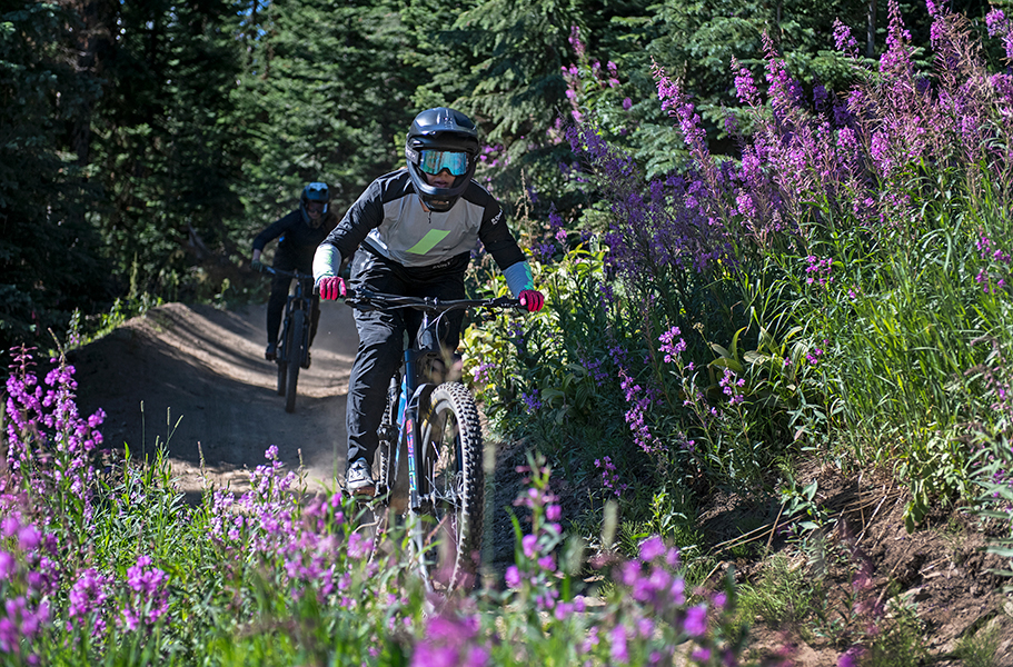 Kelly Funk Mountain bike action photography Two skilled mountain bike riders captured by Kelly Funk Photography navigate the trails at Sun Peaks Resort during spring in British Columbia, Thompson Okanagan region Canada.