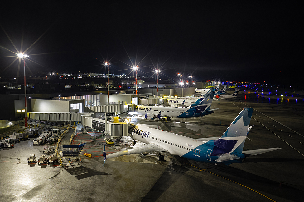 The apron at Kelowa's Internation airport captured by Kelly Funk Photography comes alive at night during the aerial drone section of a corporate marketing project for Equans services and YLW.